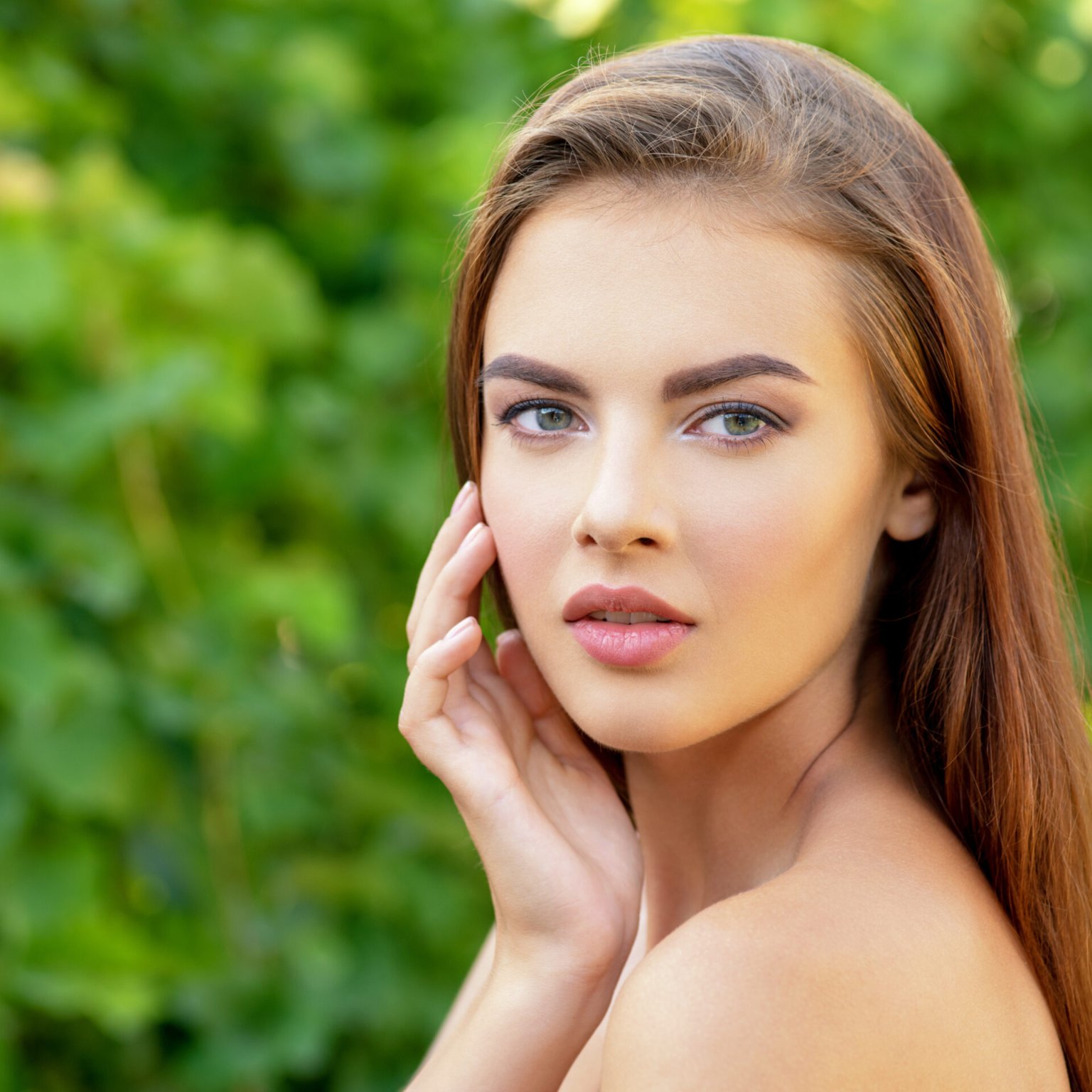 Portrait of beautiful young  woman with clean face. Beautiful face of young adult woman with clean fresh skin - nature. Face of the young beautiful sexy woman outdoors. Beauty face of young woman.